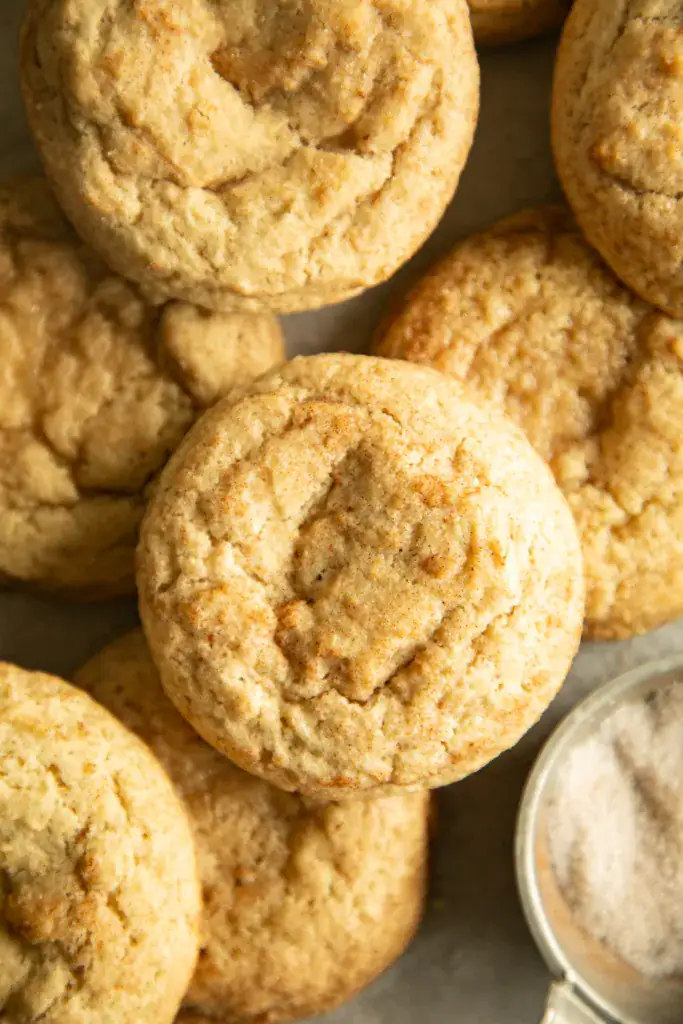 fresh baked chewy snickerdoodles on a sheet pan
