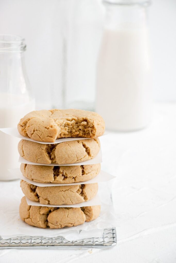 a stack of peanut butte cookies, top cookies has a bite taken out
