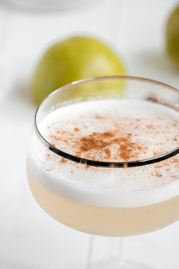 up close of a cinnamon pear gin fizz with ground cinnamon 