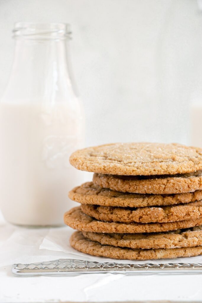cookies stacked by glass of milk