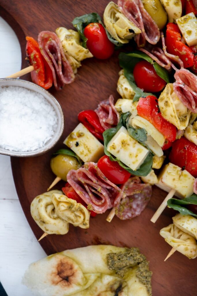 salami, cheese, tortellini, roasted red peppers, and more on a skewer