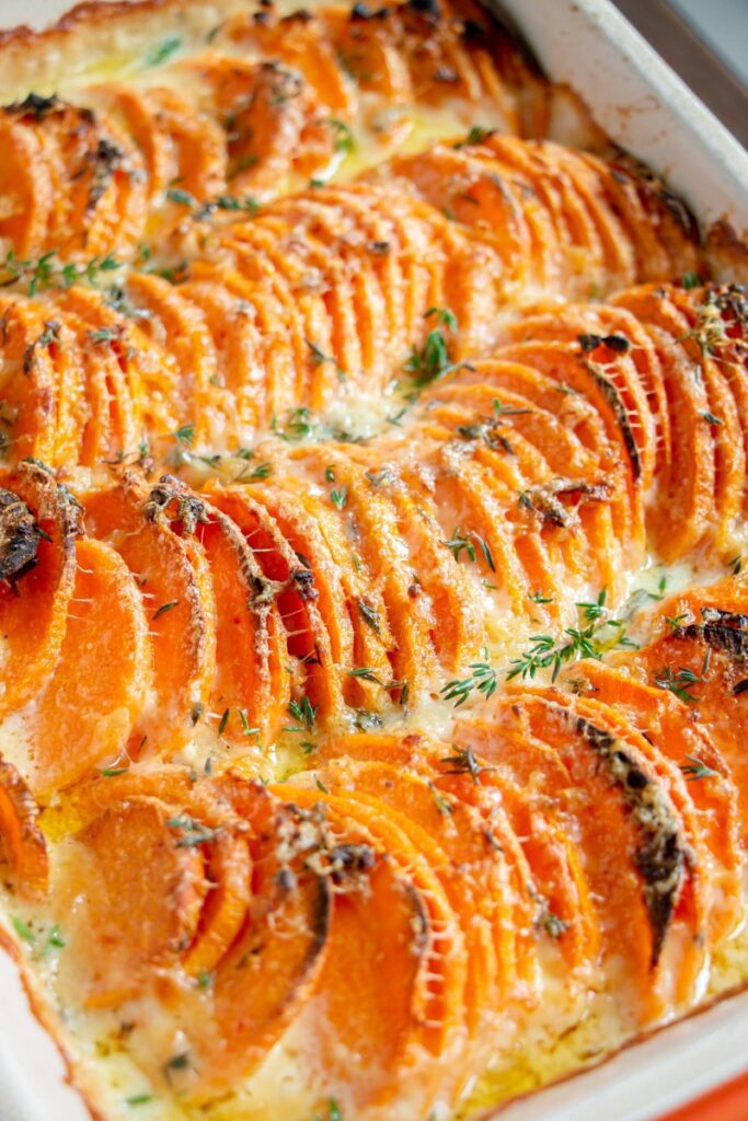 baked scalloped sweet potatoes in casserole dish 