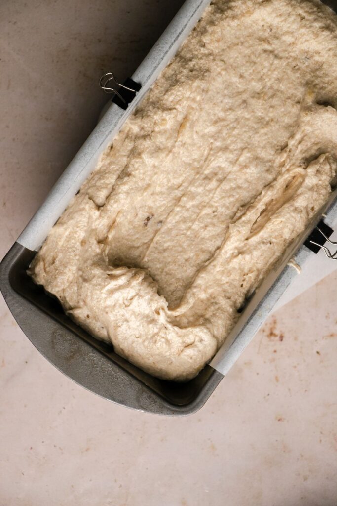 banana bread batter in greased loaf pan