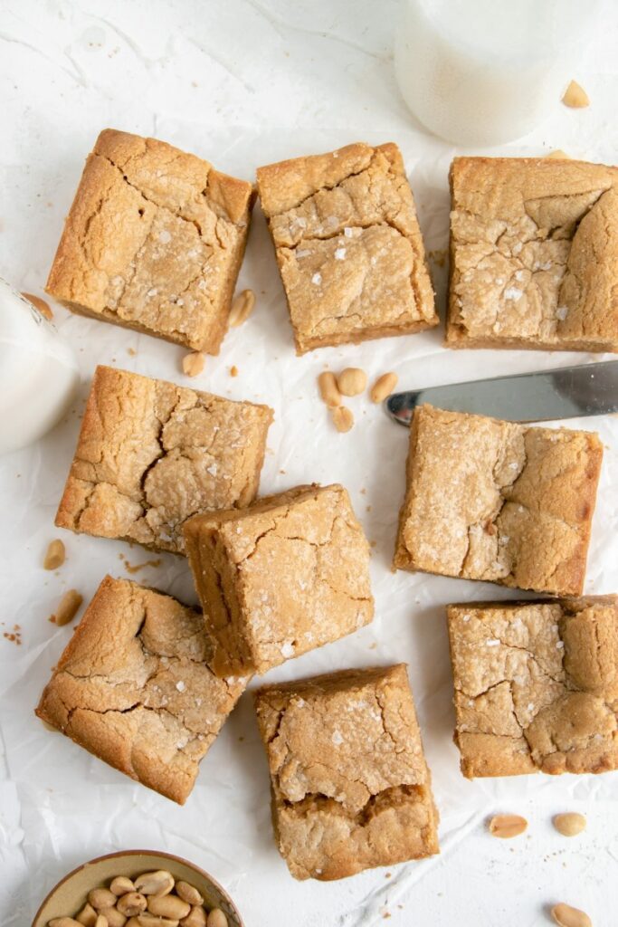sliced peanut butter blondies with a knife