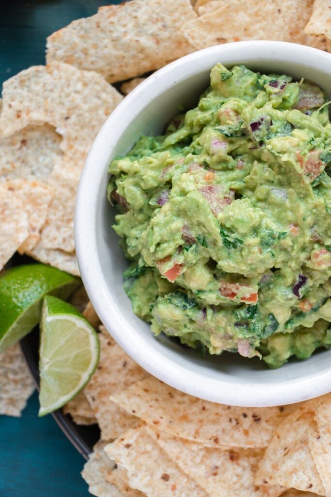 bowl of fresh guacamole served with chips
