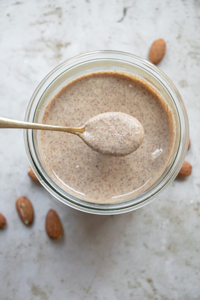 jar of homemade almond butter with spoon