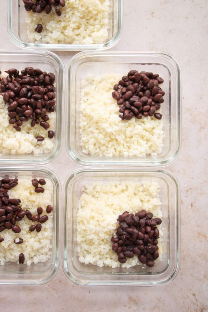 meal prep containers with cauliflower rice and black beans