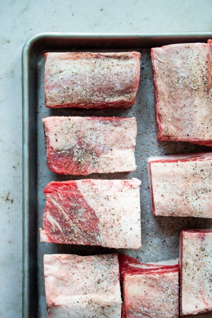 raw beef short ribs seasoned with salt and pepper