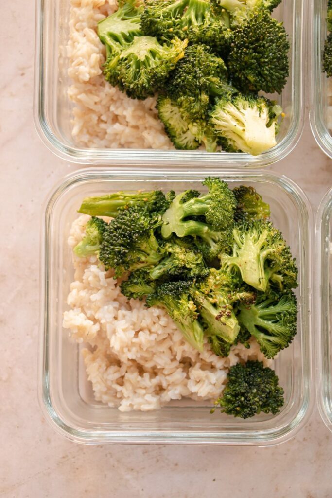 steamed rice and roasted broccoli in meal prep containers 