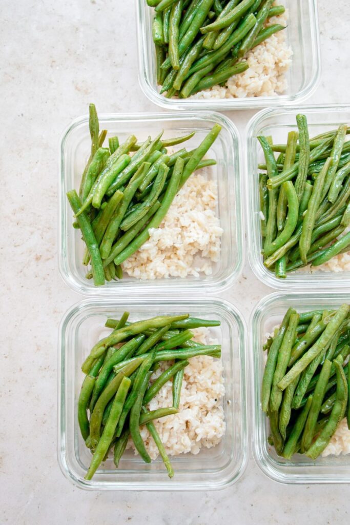 meal prep bowls with brown rice and roasted green beans 