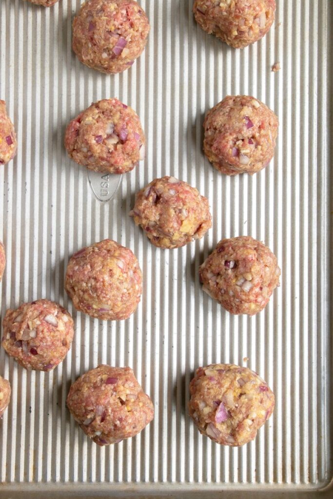 portioned meatballs on a sheet pan 