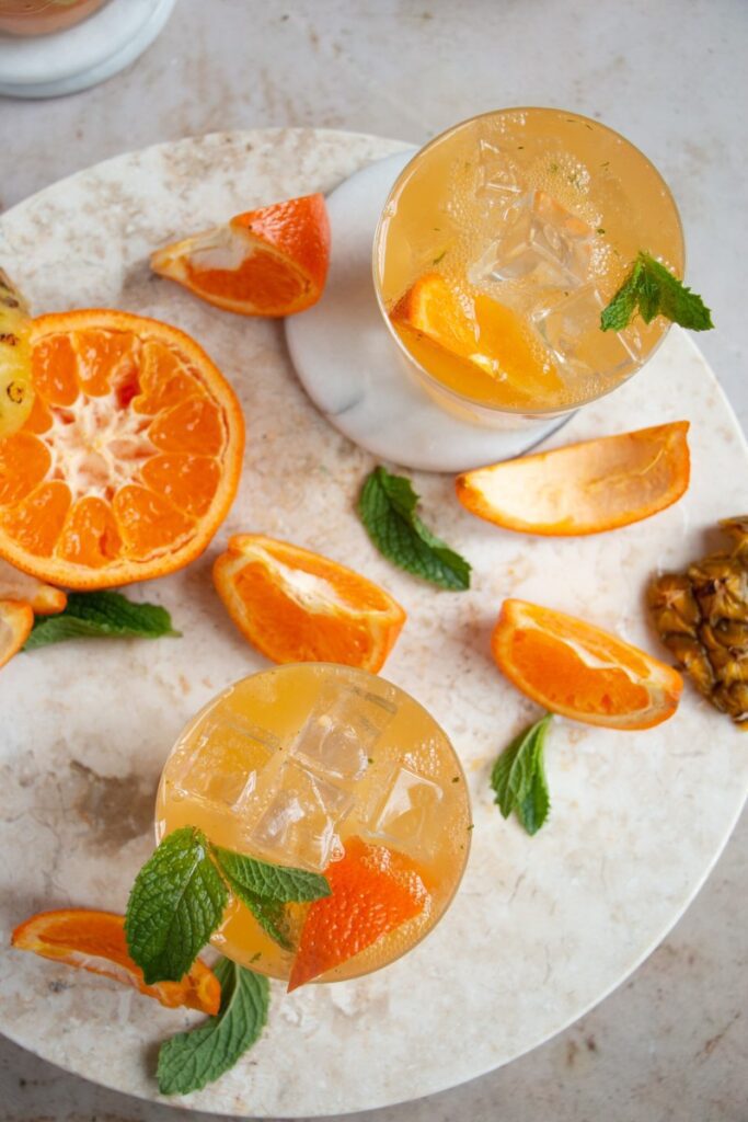 Pineapple Orange Vodka Smash Cocktail on a tray 