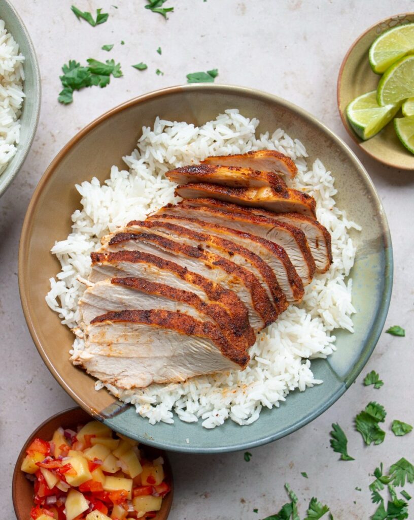 blackened chicken sliced over a bed of rice