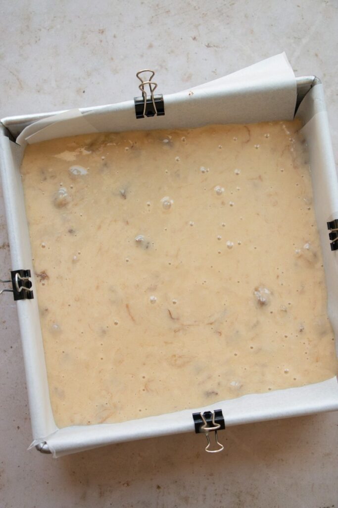 cake batter in a lined baking pan 