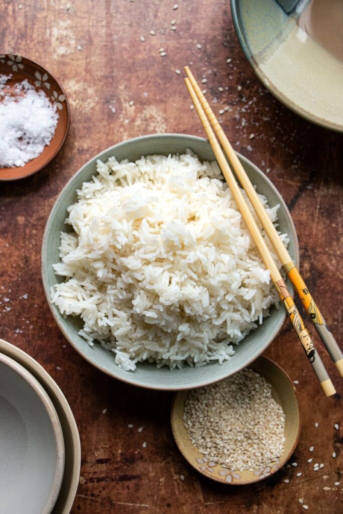 bowl of cooked rice with chopsticks 