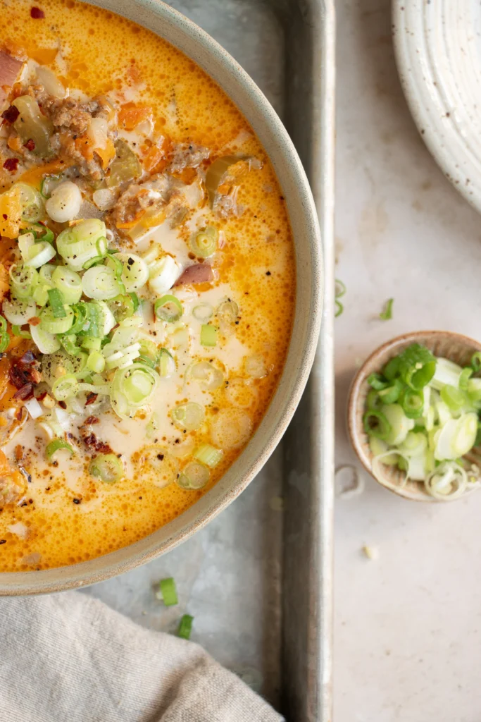 bowl of cheeseburger chowder with green onions 