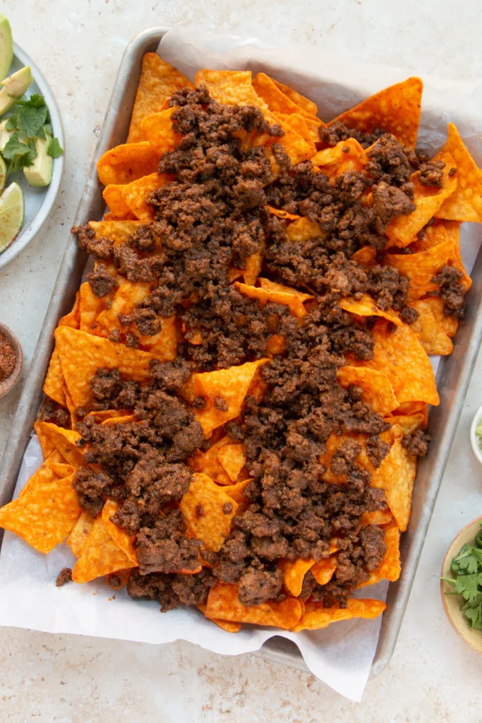 Doritos topped with taco meat 