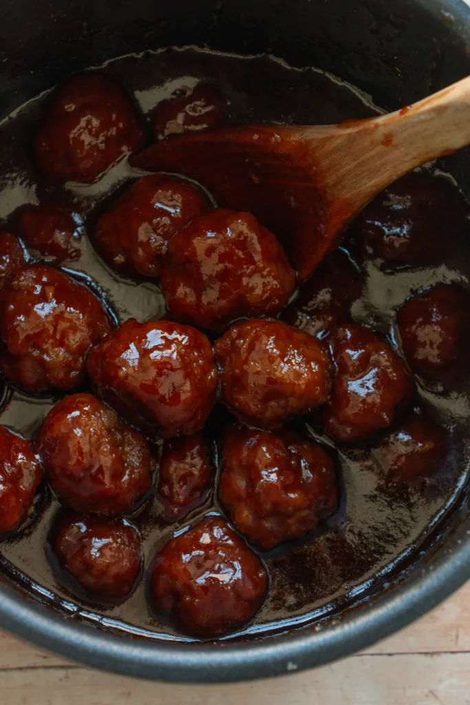 cooked beef meatballs in a grape jelly bbq sauce 