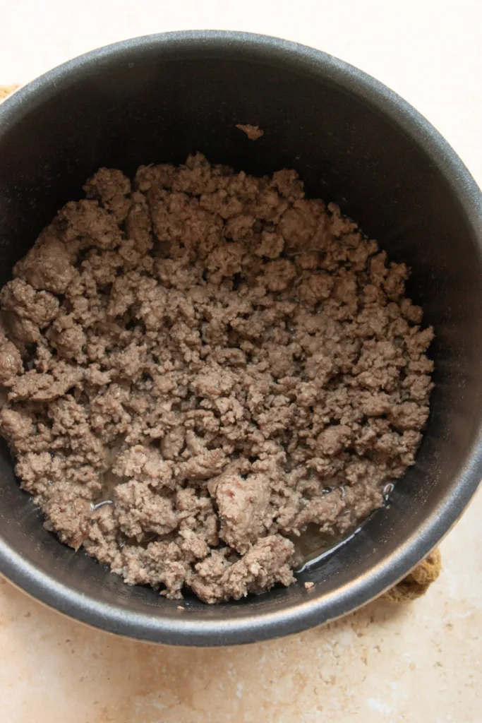 ground beef for chili cooking in an instant pot