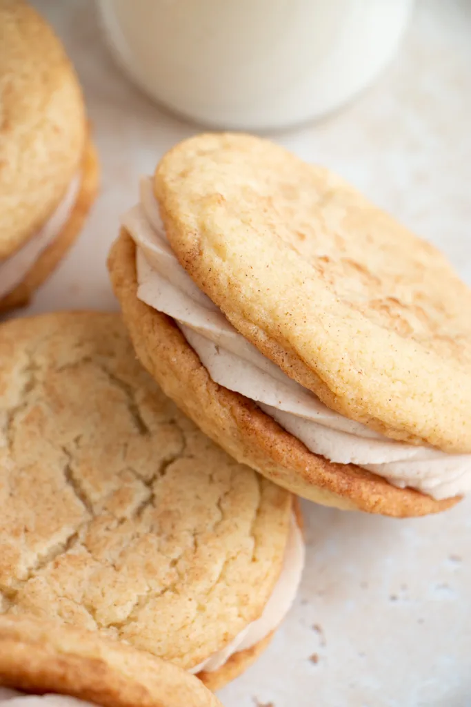 sandwich cookies with a glass of milk