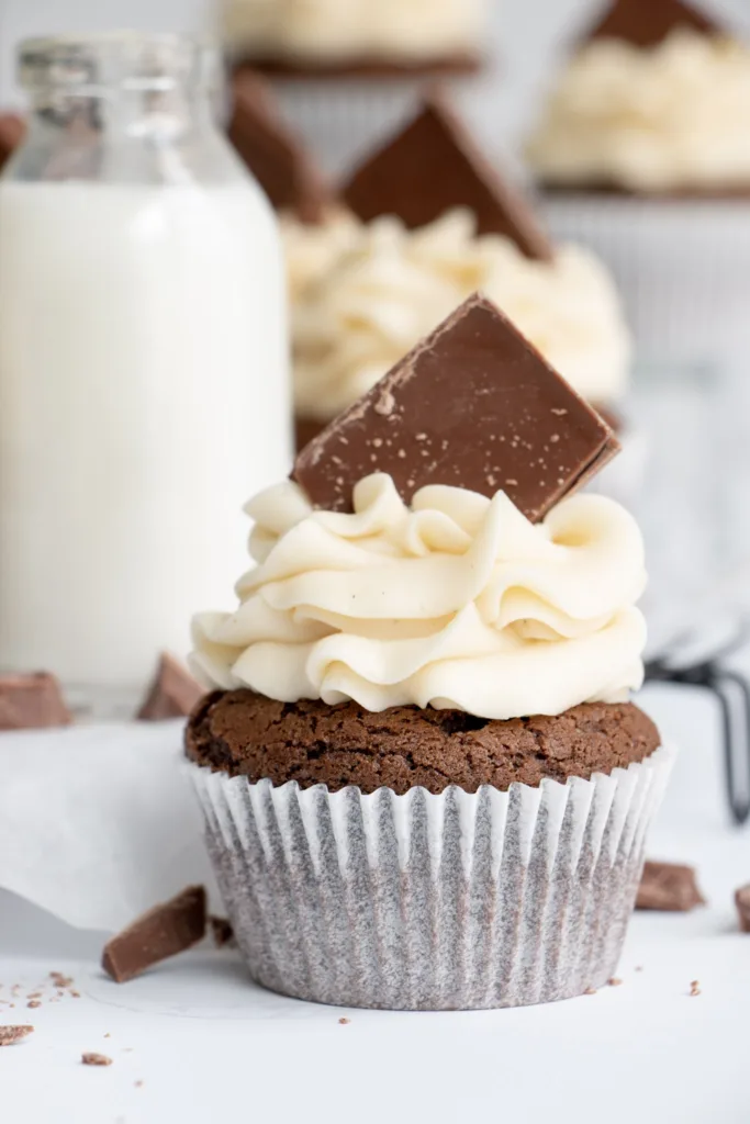 a chocolate cupcake topped with vanilla buttercream and a chocolate square