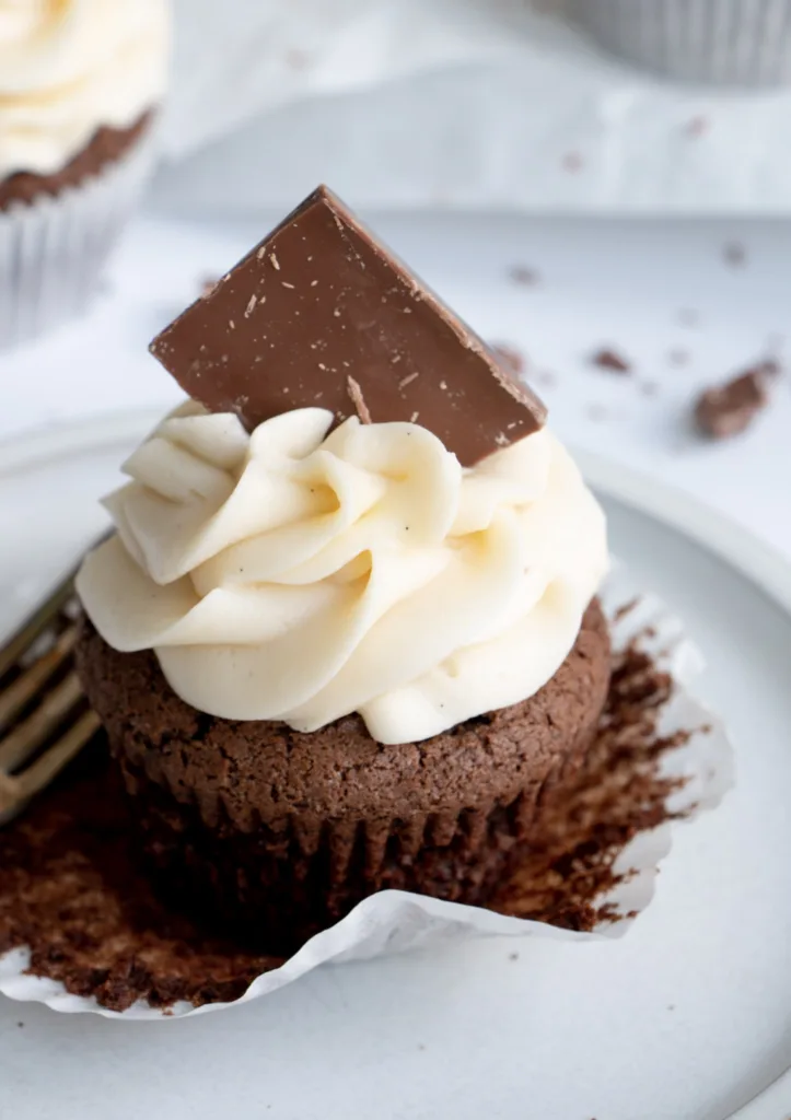 unwrapped chocolate cupcake on a plate