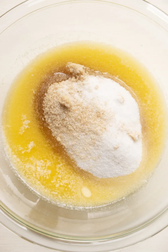 small mixing bowl with melted butter and sugars 