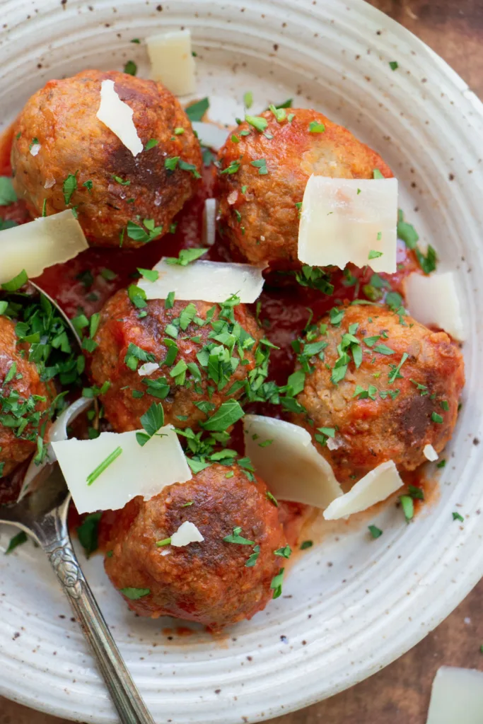 cooked turkey meatballs tossed in sauce with shredded parmesan cheese and parsley