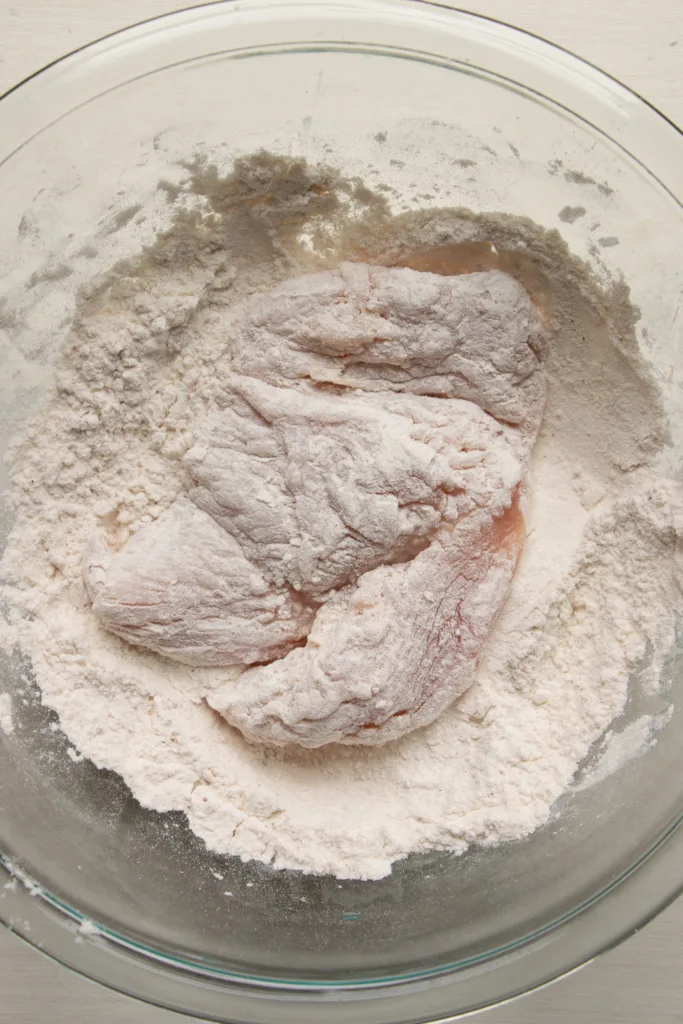 dredging chicken in flour