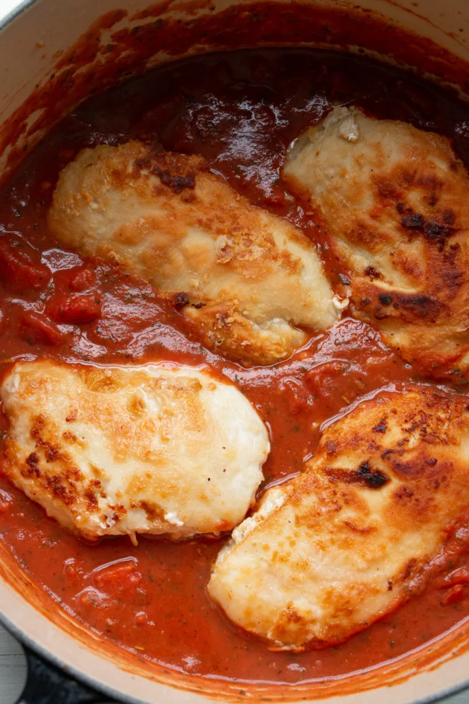 Browned chicken cutlets in tomato sauce
