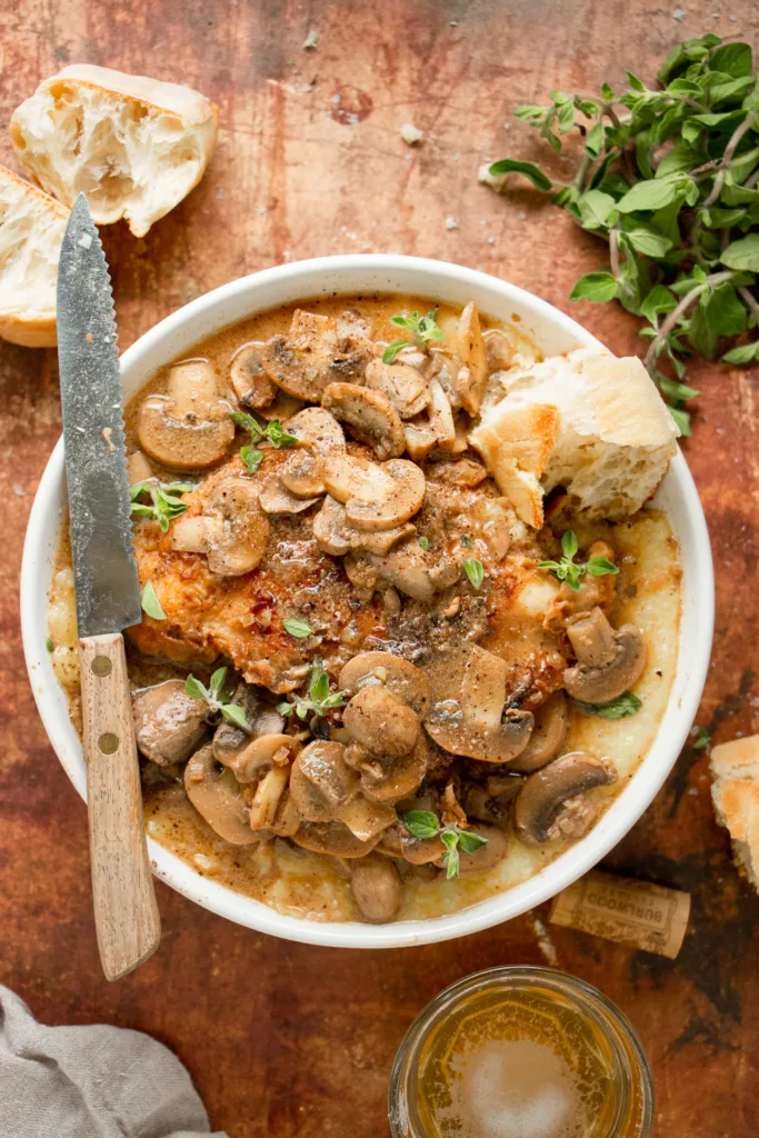 bowl of chicken marsala over grits