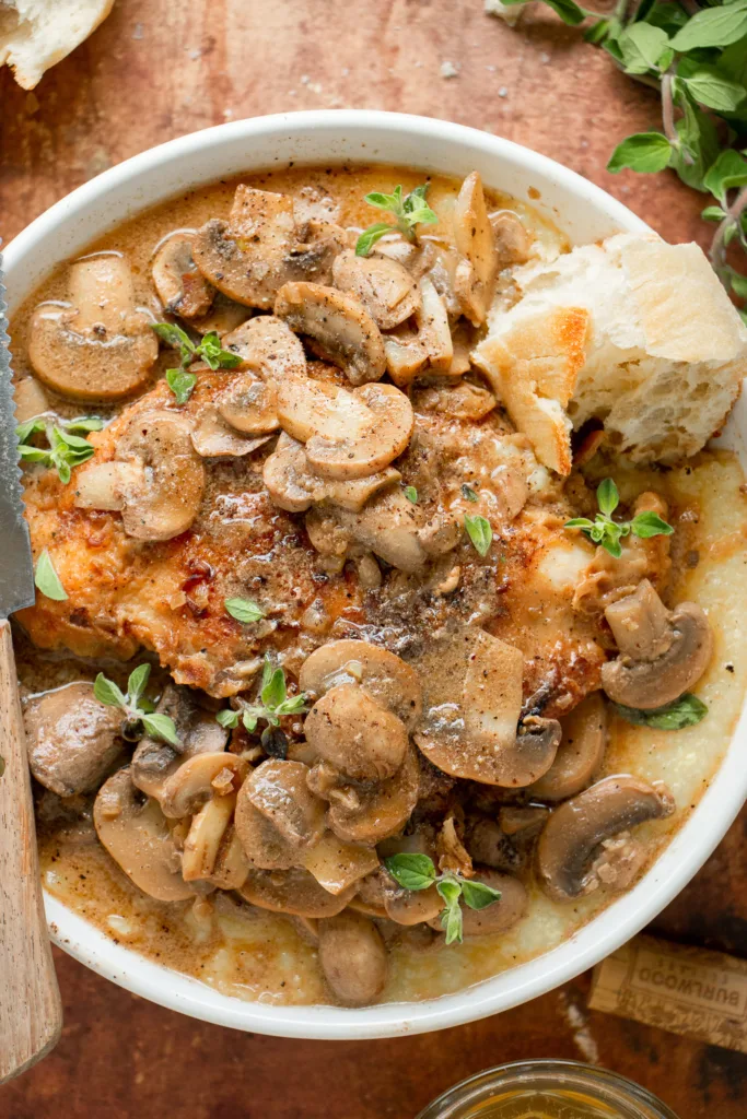 bowl of wine free chicken marsala with a baguette 