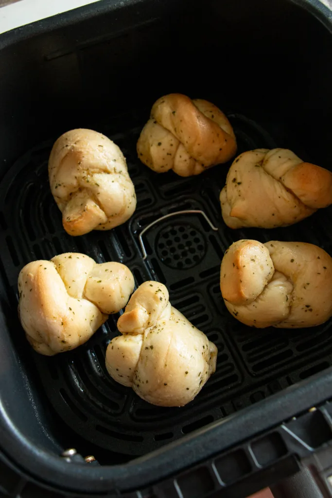 unbaked garlic knots in the air fryer basket 