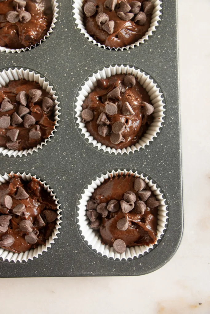 unbaked muffins in a muffin tin 