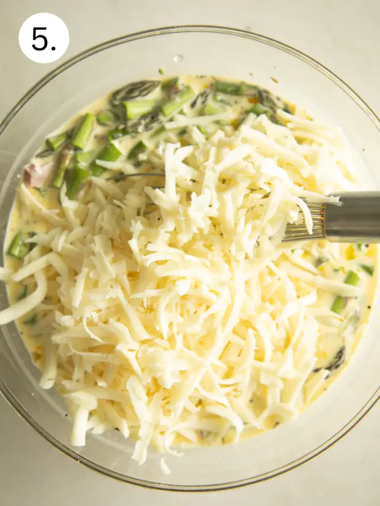 mixing bowl with the egg mixture topped with cheese