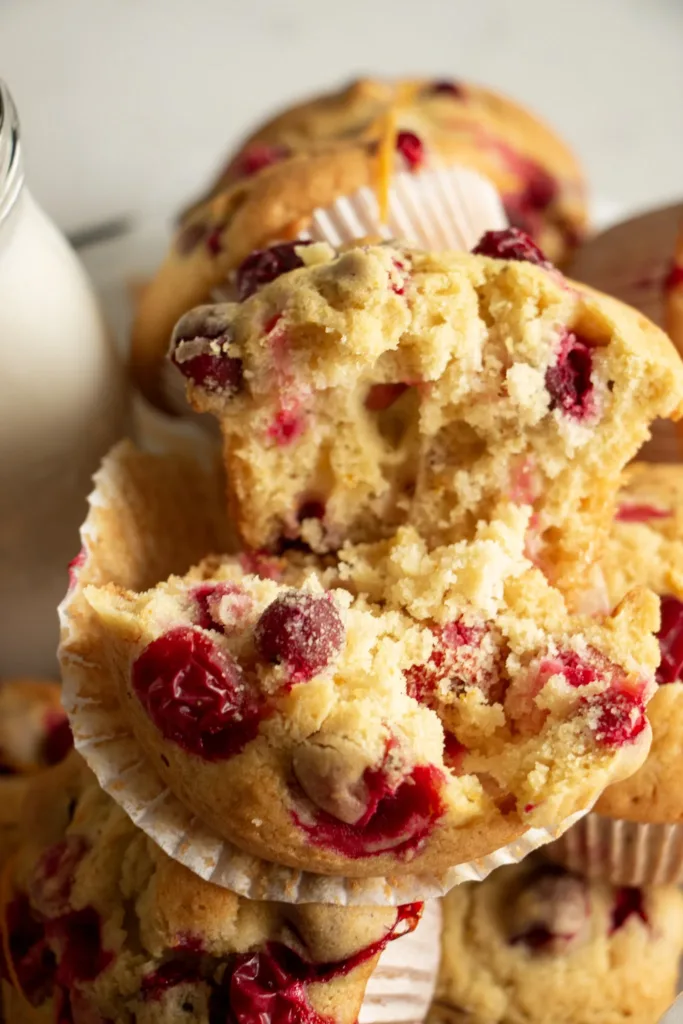 Fluffy orange cranberry muffin torn in half