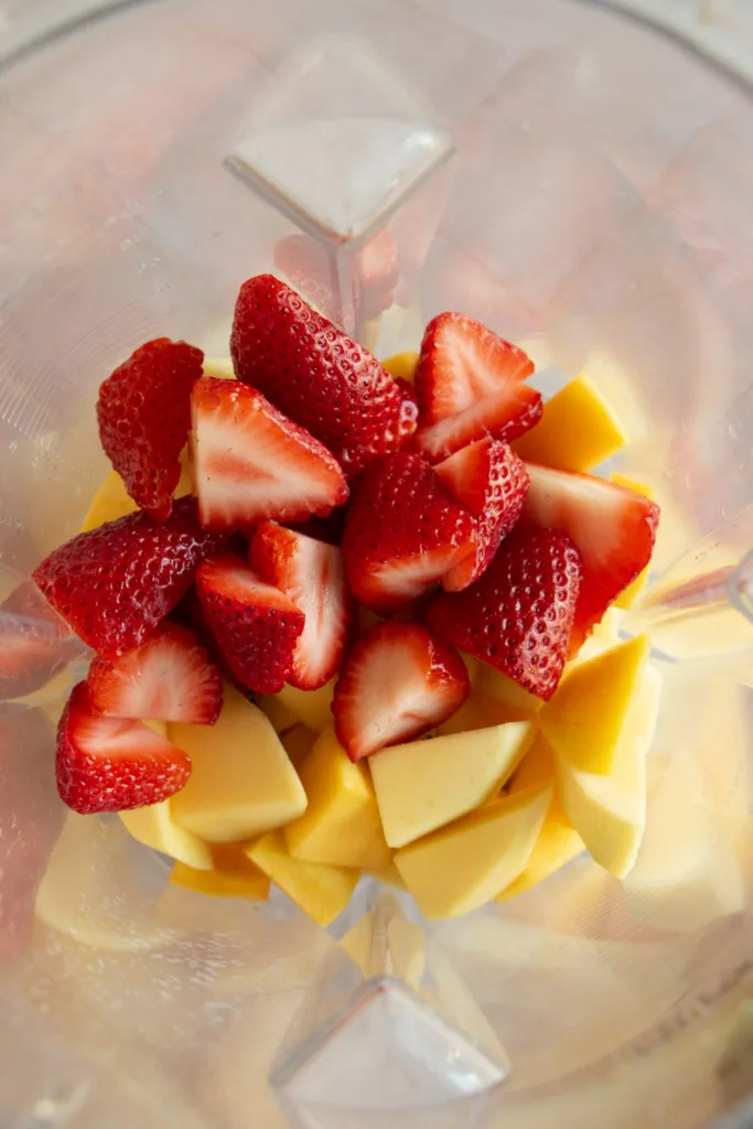 strawberries and mangos in a blender