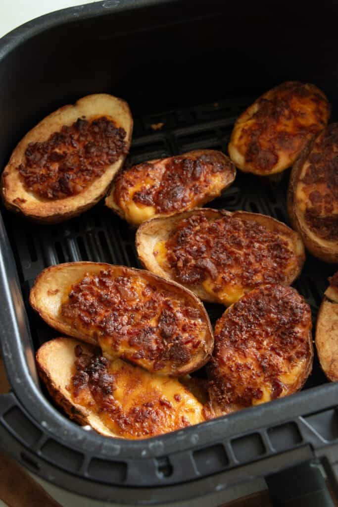 cooked potato skins in an air fryer basket