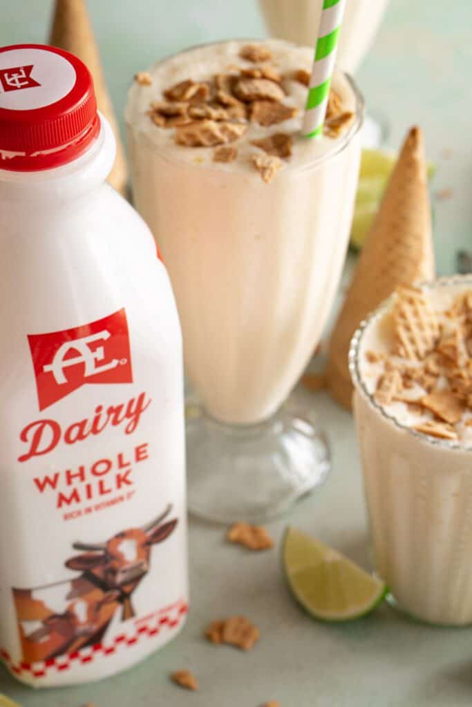 AE Dairy milk next to a glass of key lime pie milkshake 