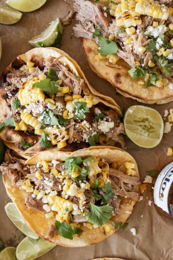 copycat chipotle pork tacos with grilled corn, cheese, and cilantro 