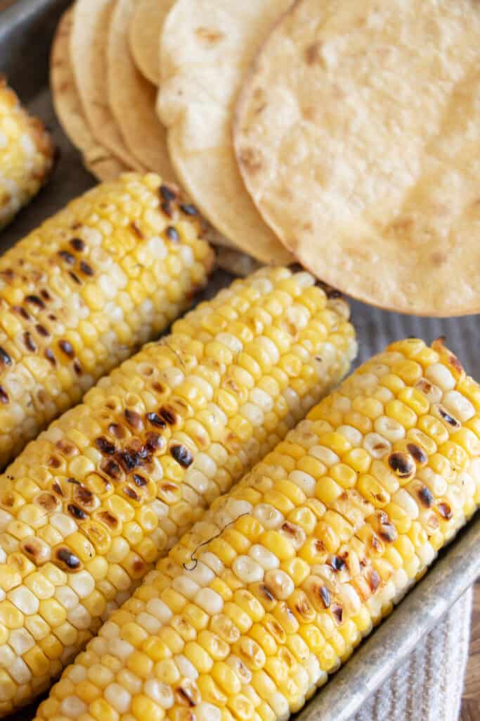 grilled corn on the cob on a sheet pan 