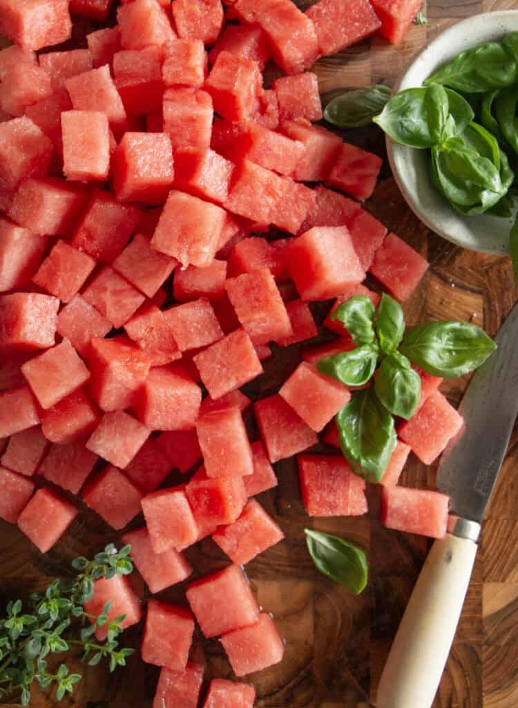 cubed watermelon on a cutting board 