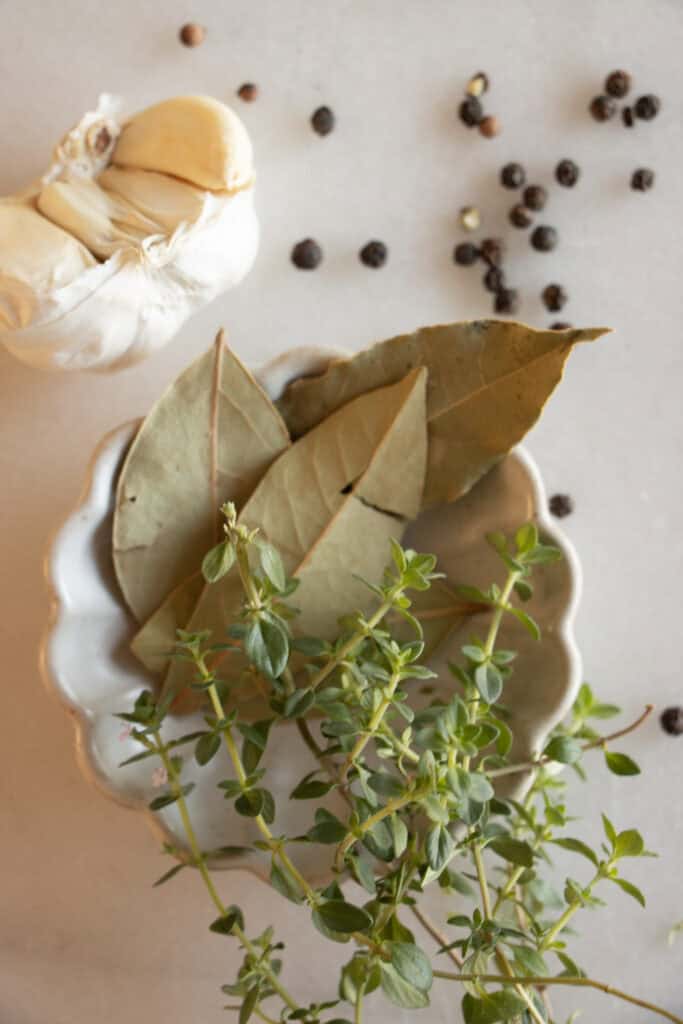 fresh thyme and bay leaves in a dish