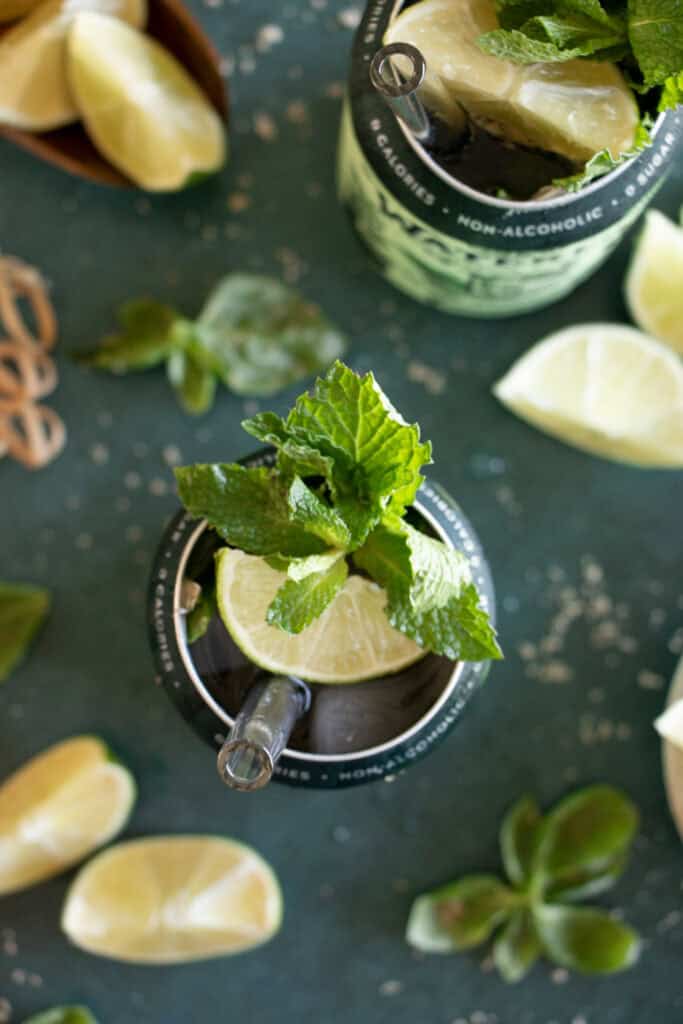 can of sparkling water with a lime wedge and a mint leaf