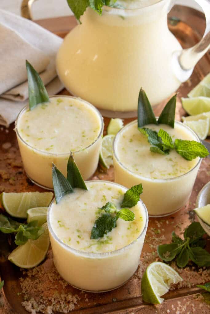 tray full of virgin pina coladas garnished with mint 