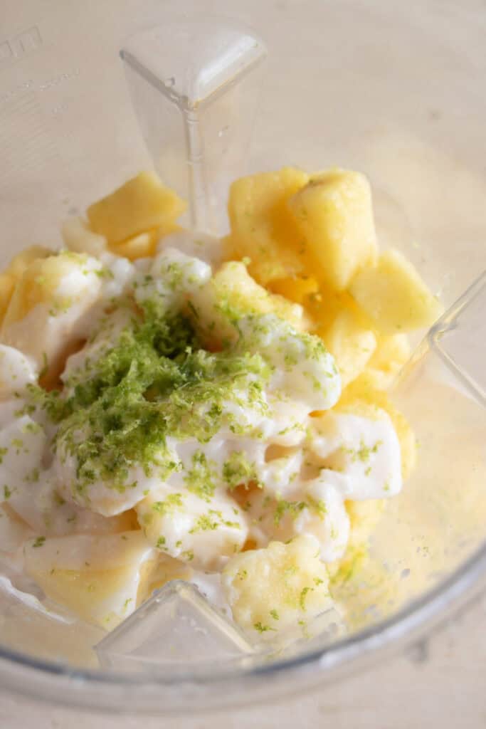 pineapple, coconut cream, and lime zest in a blender 