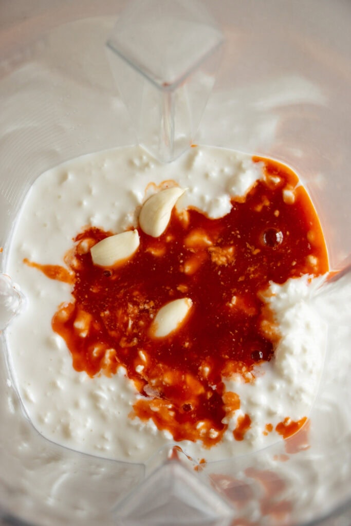 cottage cheese, hot sauce, and garlic in a blender.