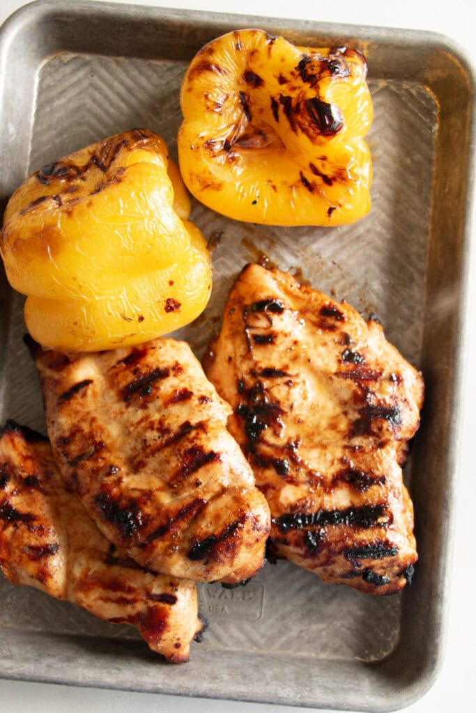 grilled chicken and bell peppers on a sheet pan