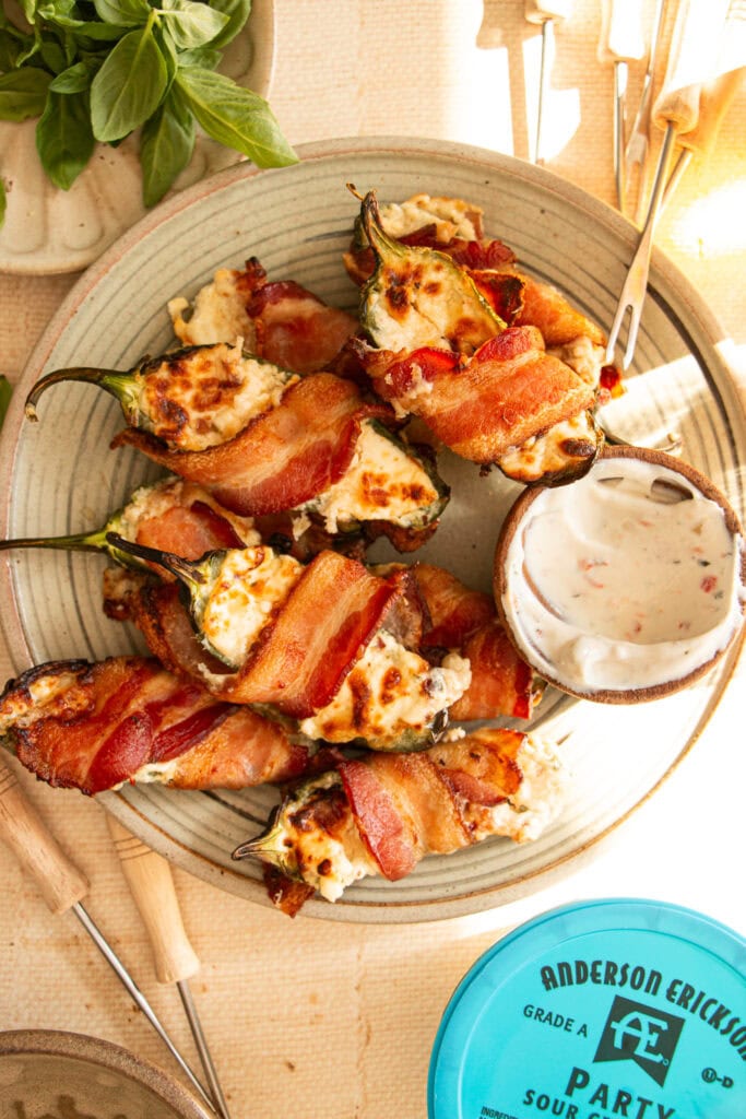 golden brown jalapeno poppers with dip and skewers 