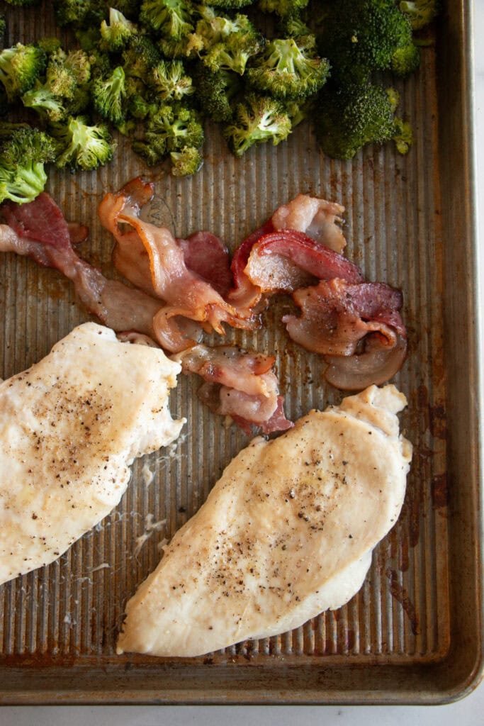 sheet pan with cooked chicken, bacon, and broccoli